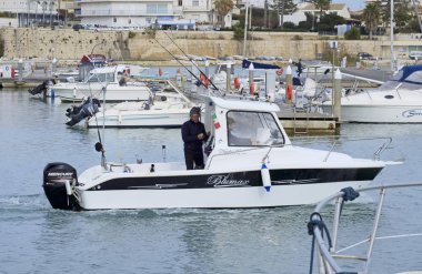 Italy, Sicily, Mediterranean Sea, Marina di Ragusa (Ragusa Province); 13 February 2020, fishermen on a motor boat in the port - EDITORIAL