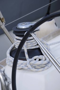 Italy, Sicily, Mediterranean Sea, Marina di Ragusa (Ragusa Province); 13 February 2020, the boat's wheel, a winch and nautical ropes on a sailing boat in the port - EDITORIAL