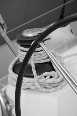 Italy, Sicily, Mediterranean Sea, Marina di Ragusa (Ragusa Province); 13 February 2020, the boat's wheel, a winch and nautical ropes on a sailing boat in the port - EDITORIAL