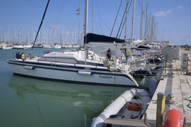 Italy, Sicily, Mediterranean Sea, Marina di Ragusa (Ragusa Province); 11 March 2020, man on a sailing boat in the port - EDITORIAL