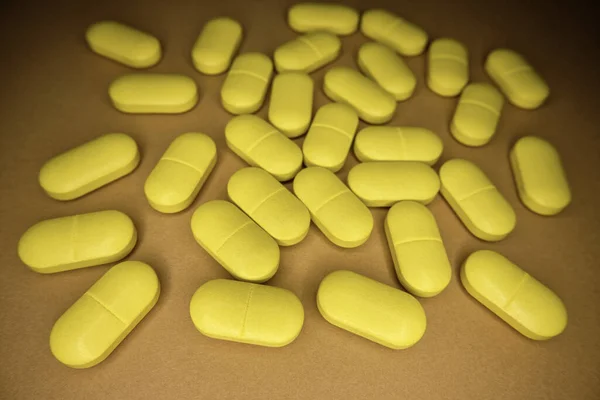 Medicine; yellow pills on a table