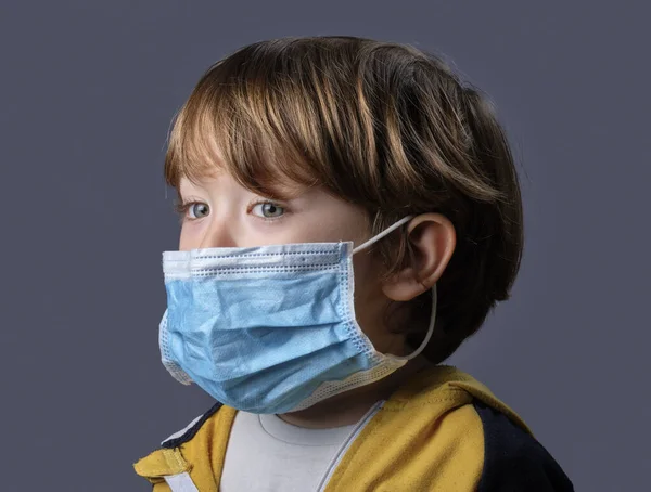 Studio portrait of a 4 years old male child wearing a protective mask