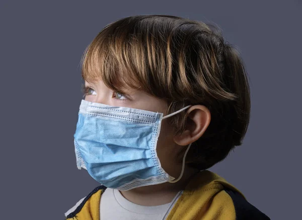 Studio portrait of a 4 years old male child wearing a protective mask