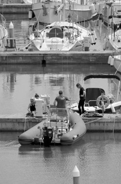 İtalya, Sicilya, Akdeniz, Marina di Ragusa (Ragusa Eyaleti); 17 Mayıs 2020, limandaki insanlar, motorlu tekneler ve lüks yatlar - EDITORIAL