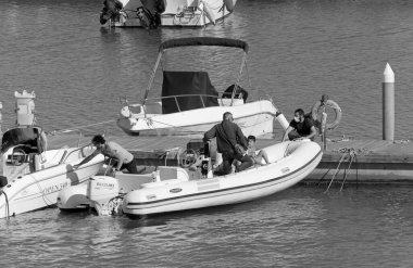 İtalya, Sicilya, Akdeniz, Marina di Ragusa (Ragusa Eyaleti); 22 Mayıs 2020, limandaki kauçuk bir teknede insanlar - EDITORIAL