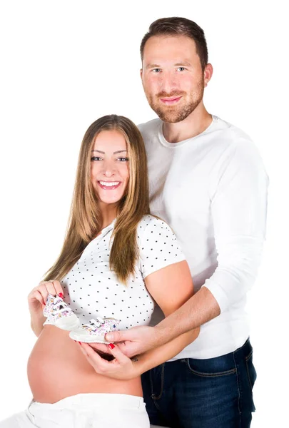 Pregnant young woman with man in studio — Stock Photo, Image