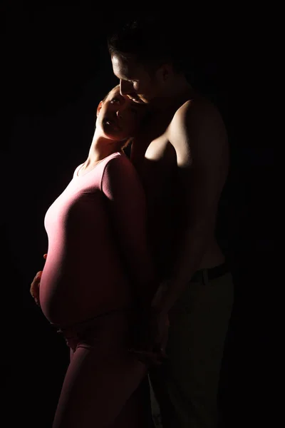 Pregnant young woman with man in studio — Stock Photo, Image