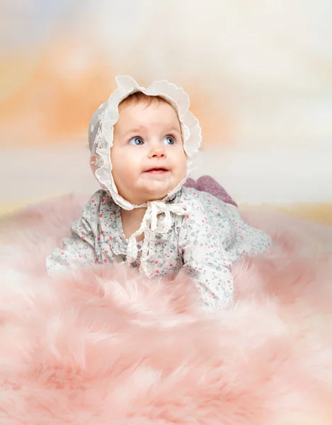 Attractive 6 month old baby girl in colorful dress — Stock Photo, Image