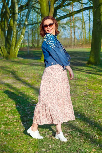 Portrait of middle aged woman posing at the park Stock Picture