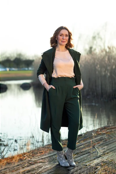 Portrait of middle aged woman posing at the park — Stock Photo, Image