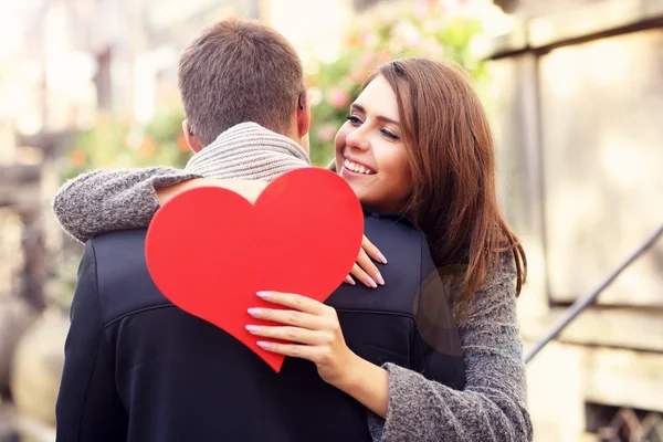 Woman with heart giving hug to  man — Φωτογραφία Αρχείου