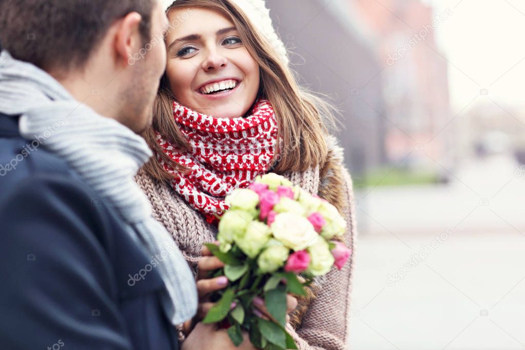 Young couple with flowers dating in the city
