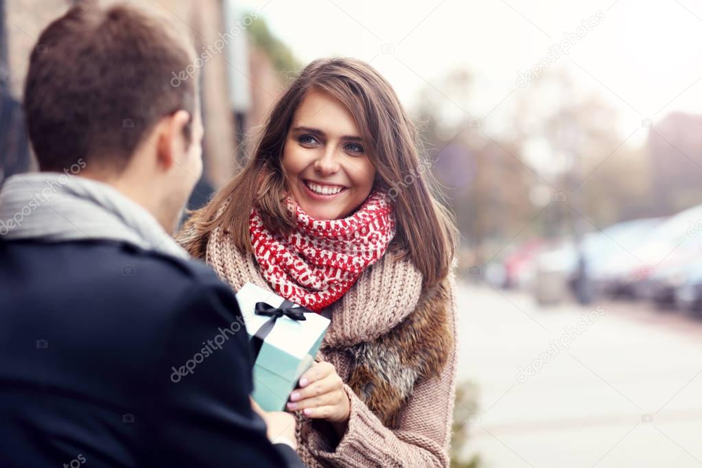 Young couple with present in the park