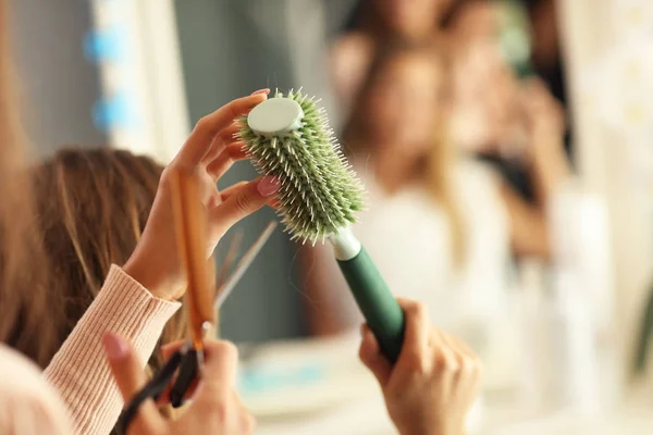 Hairdresser with hair brush