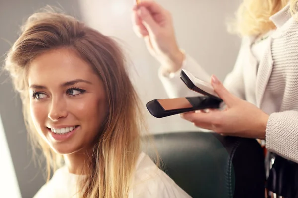 Hairdresser using hair straightener
