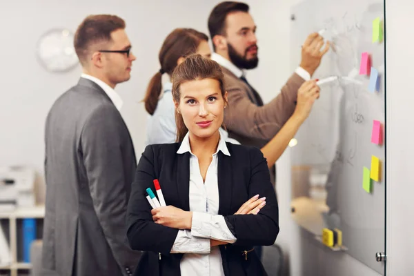 Confident businesswoman and her team — Stock Photo, Image