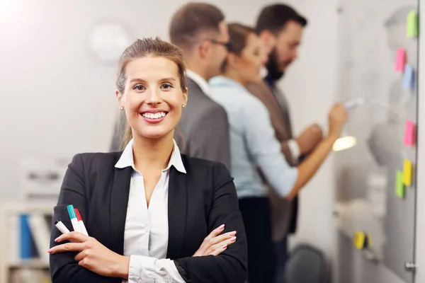 Confident businesswoman and her team — Stock Photo, Image