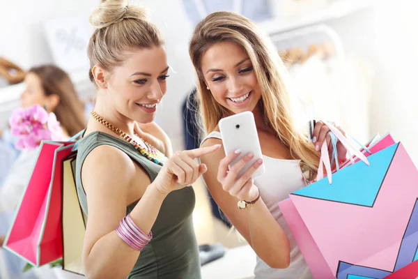 Happy friends shopping in store — Stock Photo, Image