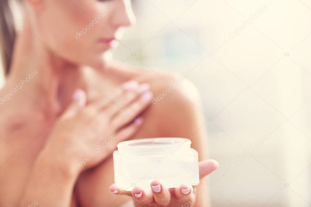  fit woman holding lotion 
