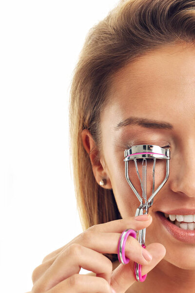 woman using eyelash curler
