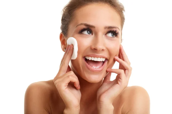 Woman smiling at camera and using cotton — Stock Photo, Image