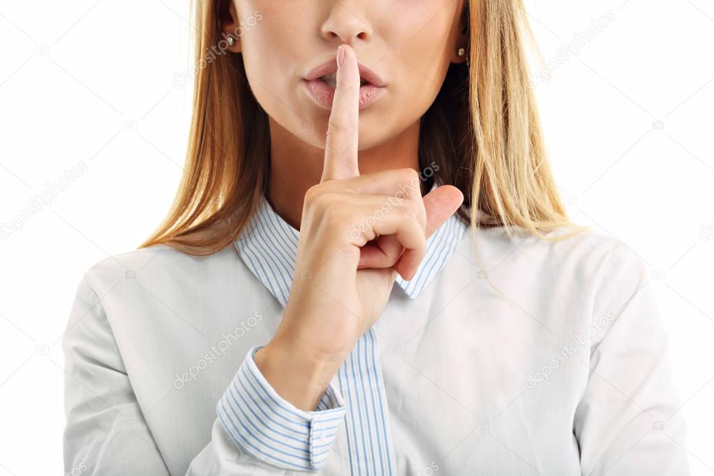 woman holding a finger on her lips