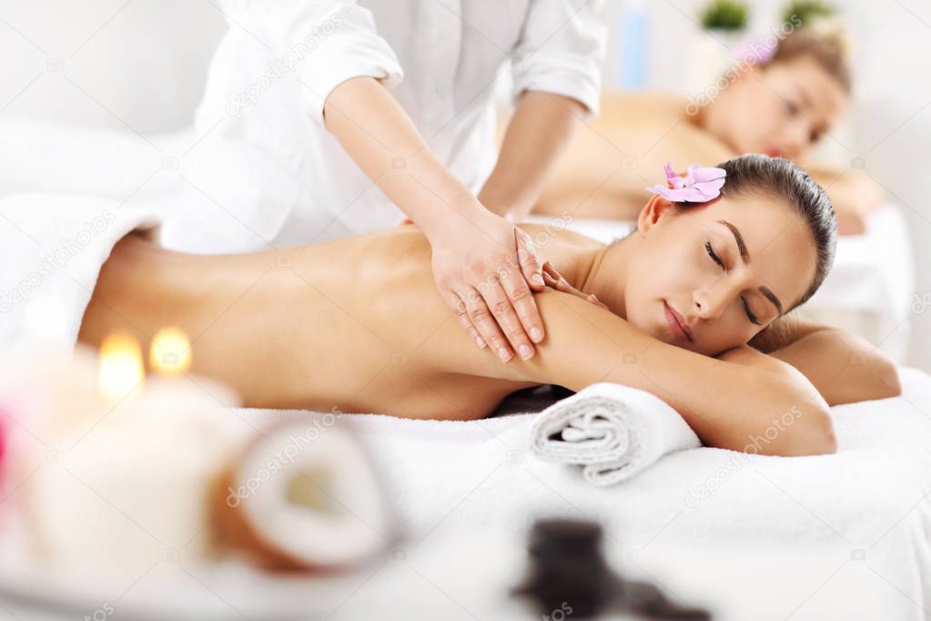 women getting massage in spa