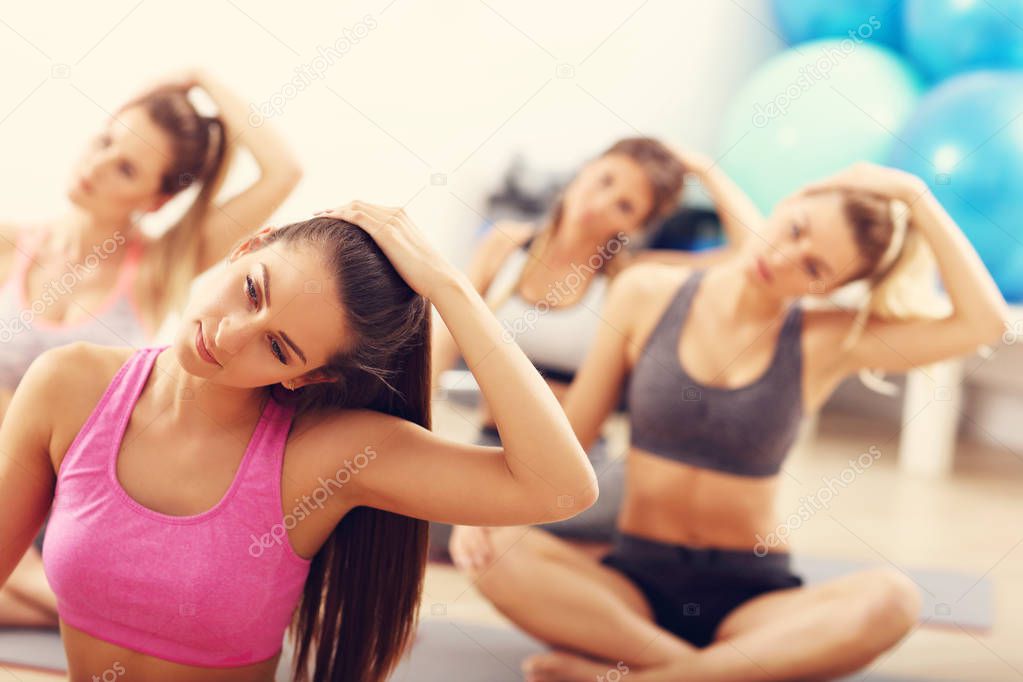  female group practicing yoga