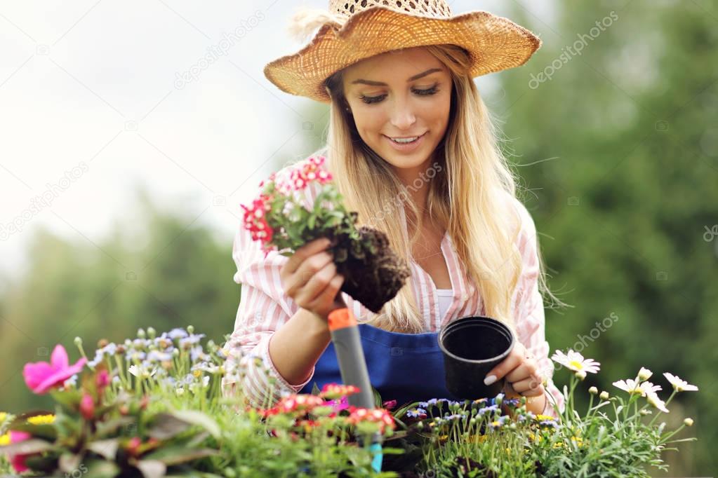 Woman growing flowers outside
