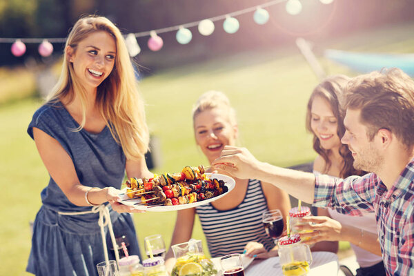 Friends having barbecue party Royalty Free Stock Images