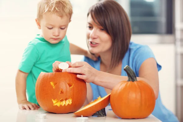 Mother and son preparing jack-o-lantern — Stock Photo, Image