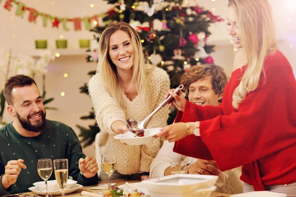 Group of family and friends celebrating Christmas dinner — Stock Photo, Image