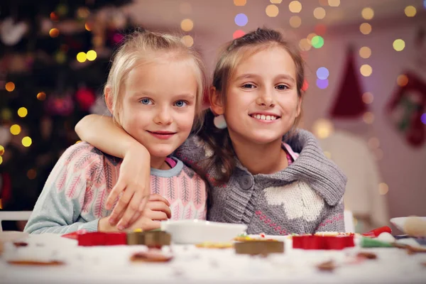 Happy little sisters preparing Christmas biscuits — Stock Photo, Image