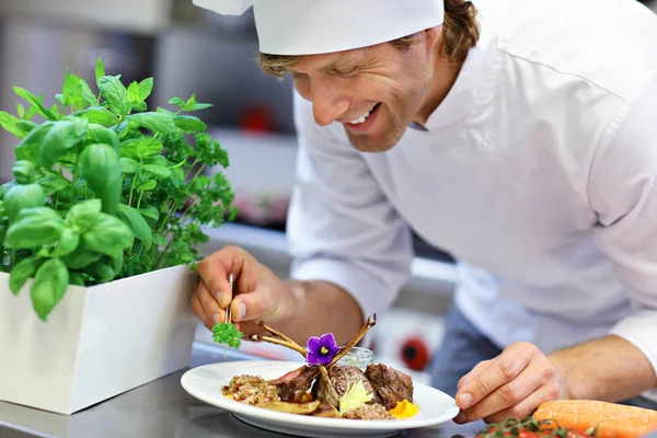 Busy chef at work in the restaurant kitchen