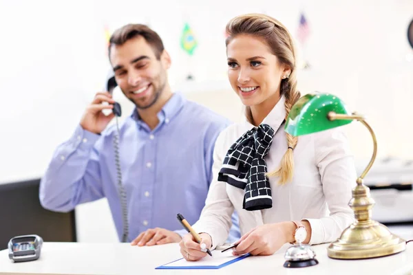 Happy team of hotel receptionists — Stock Photo, Image