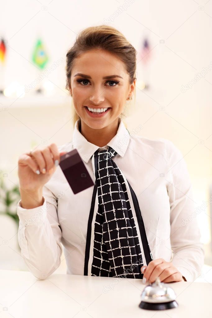 Happy receptionist working in hotel