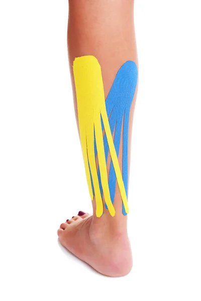 Picture showing special physio tape put on injured calf over white background — Stock Photo, Image