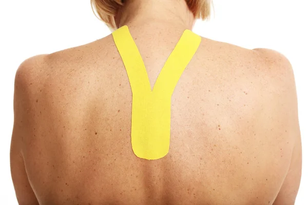 Picture showing special physio tape put on injured back over white background — Stock Photo, Image