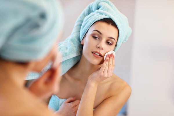 Young woman standing in bathroom in the morning