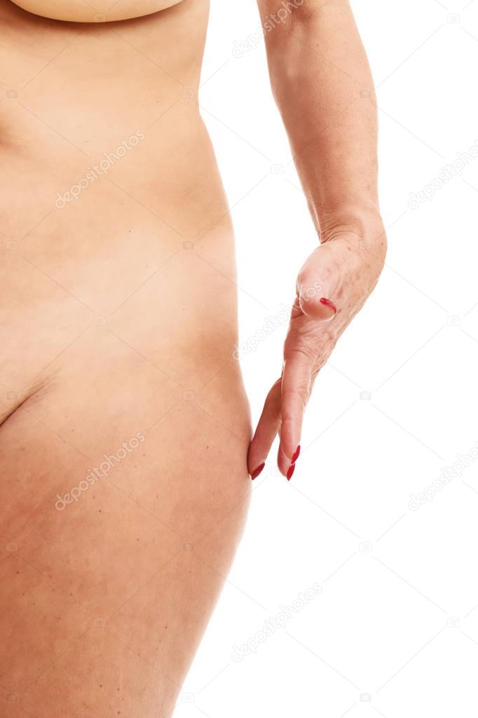 Senior woman touching abdomen over white background