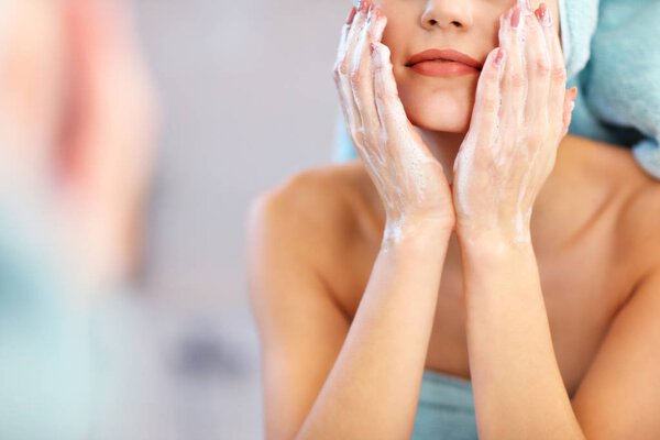 Young woman standing in bathroom in the morning