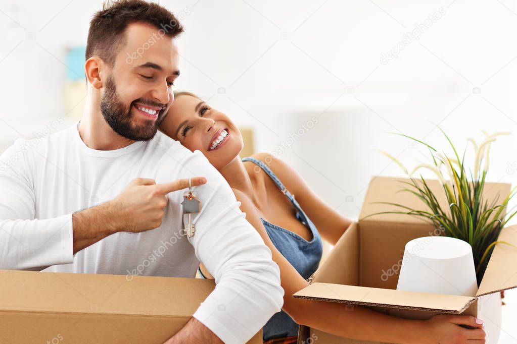 Picture showing happy adult couple moving out or in to new home