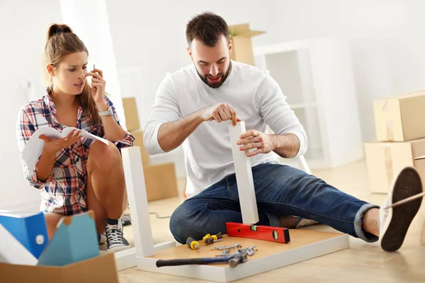 Happy adult couple moving out or in to new home — Stock Photo, Image