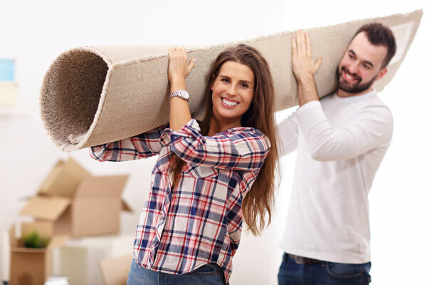 Happy adult couple moving out or in to new home