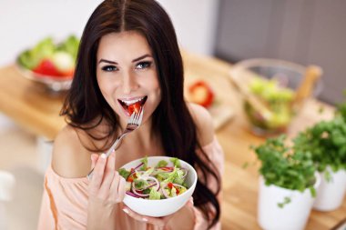 Mutlu kadın modern mutfak salata hazırlık
