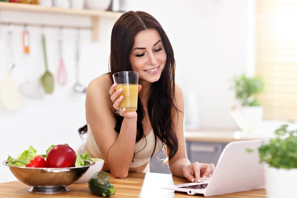 Fit lächelnde junge Frau mit gesundem Saft in moderner Küche — Stockfoto