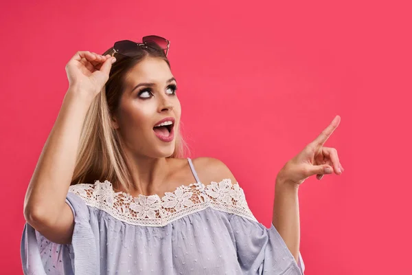 Beautiful adult woman posing over pink background — Stock Photo, Image