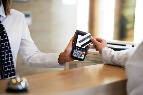 Receptionist and businesswoman at hotel front desk