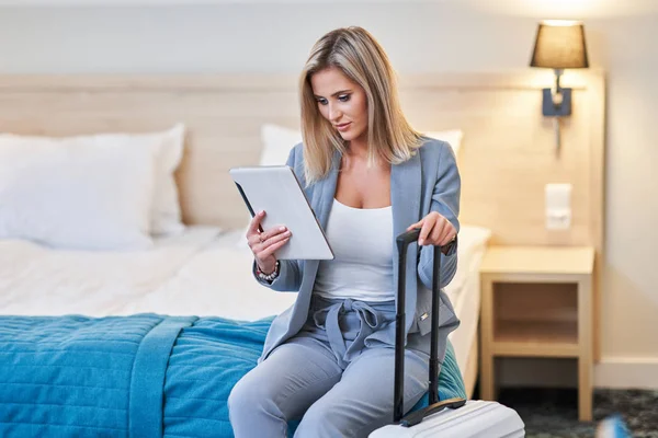 Zakenvrouw gebruikt tablet computer in hotelkamer — Stockfoto