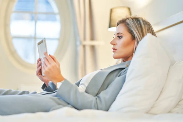 Businesswoman using tablet computer in hotel room — Stock Photo, Image